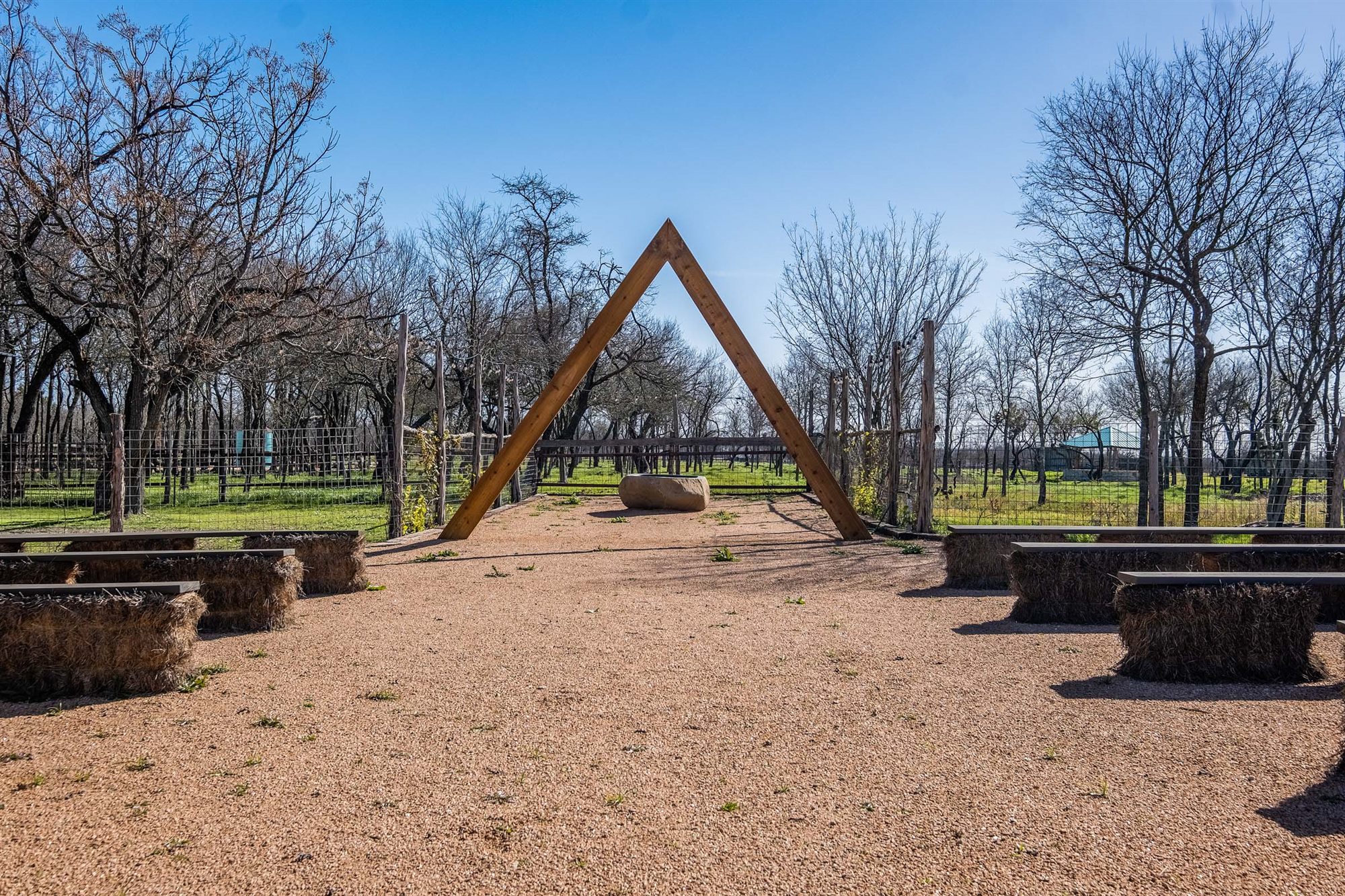 Timber wedding arch at the end of the ceremony aisle