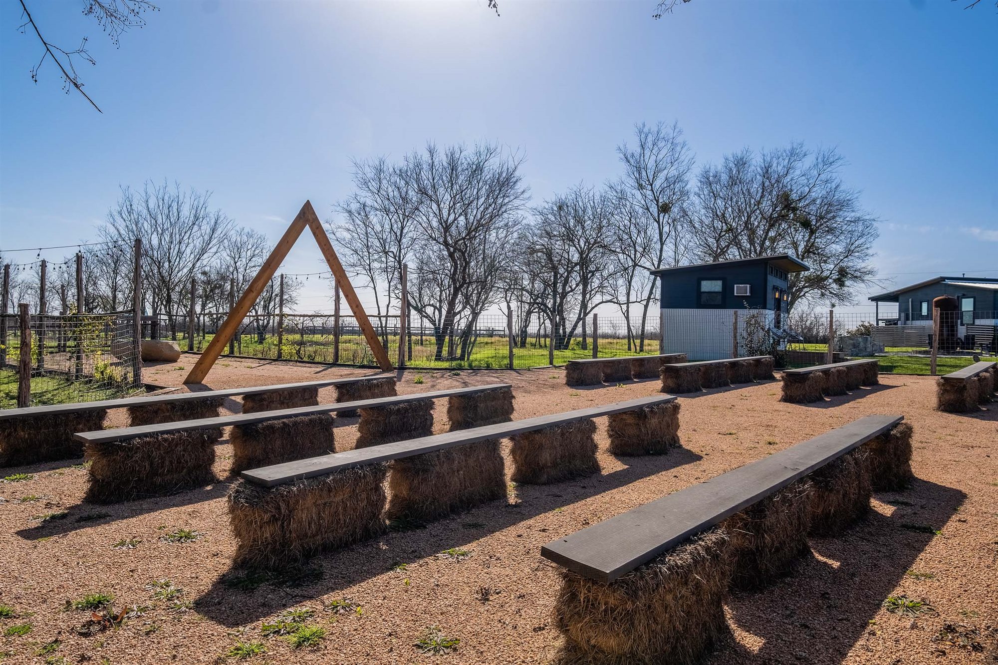 Hay-bale bench seating in the outdoor ceremony space